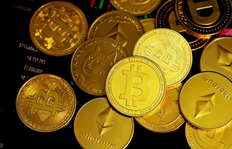 Crypto - a pile of gold bitcoins sitting on top of each other